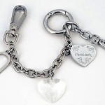 POLISHED SILVER SIGNATURE HEART TRIO Fun, Useful & Unique! This new accessory makes an incredible fashion statement and secures your purse, zipper and keys within seconds! No one should carry their handbag without a PersLock! Steel Chain Base Metal Clips Secures Handbag to Object, ie: chairs/grocery carts Secures Zipper to prevent pick-pocketing Key Holder Accessorizes Handbag Directions: 1) Attach PersLock to the metal hardware on purse (or strap) on handbag by depressing hinged round ring on PersLock. 2) To deter purse theft when you are distracted, secure purse to object such as a chair; unclip large clip from round gate ring, wrap chain around post on chair and reattach clip to gate ring. 3) To deter pick pocketing; Close zipper, attach smaller clip on PersLock to zipper tag. 
