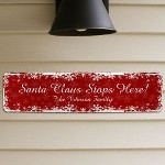 Personalized Santa Stops Here Sign - Custom Printed Santa Claus Wall Sign Let everyone know that Jolly Santa Claus stops at your house every Christmas with your own Personalized Santa Claus Stops Here Decorative Metal Sign. Perfect for use indoors or outdoors, this adorable sign is perfect for spreading Holiday cheer and the joy of Santa for children of all ages. 