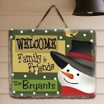 Personalized Christmas Slate Plaque - Personalized Holiday Natural Slate Plaque Decorate your home in holiday cheer with a unique slate plaque featuring a romantic winter scene. A beautiful accent for your home to welcome friends and family during this heartwarming time of the year. Your Personalized Holiday Natural Slate Plaque measures 11" x 9". Each natural slate plaque arrives with a leather strap for wall hanging. Includes FREE Personalization! Personalize your slate plaque with any family name. (i.e. The Bryants )