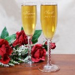 Personalized Wedding Toasting Flutes - Personalized Couples Champagne Glasses It is your day to shine and celebrate the union created by two loving people. Let the champagne flow & the merriment ring across the land with your own Personalized Wedding Toasting Flutes. Each glittering champagne flute is beautifully engraved with exact precision & clarity. These unique wedding keepsakes also make perfect anniversary keepsakes for celebrating the First to the 100th wedding anniversary. Your Personalized Couples Champagne Glasses are available Angelic Twisted Stem Toasting Flutes. The Personalized Champagne Flutes feature 12 knotted twist stems and measure 8 1/4”H. Champagne Flutes are made in the USA and hold 5.75 ounces. Includes FREE Personalization! Personalize your Wedding Toasting Flutes with any bride and grooms names and wedding date. Your Personalized Couples Champagne Glasses are available on Glitter Galore Toasting Flutes. The Personalized Champagne Flutes feature sparkling rhinestone accents along with nickel-plated metal stems and measure 10 1/8”H. Includes FREE Personalization! Personalize your Wedding Toasting Flutes with any bride and grooms names and wedding date. 