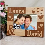 Personalized Couple Picture Frame - Perfect Valentines Day Picture Frame Celebrate the love you have for one another by displaying your favorite Couple photograph in this unique Personalized Couple Picture Frame. This lovely Personalized Picture Frame makes a great Personalized Valentines Day Gift for Her or Him. Your Engraved Couples Picture Frame measures 8 3/4" x 6 3/4" and holds a 3.5" x 5" or 4" x 6" photo. Easel back allows for desk display or can be wall hung. Engraved personalization features the natural wood grain color. Personalized picture frame includes FREE personalization! Personalize your Couple Picture Frame with any two names. (ie. Laura\David)