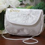 Your Embroidered First Communion Purse includes an ornate satin purse embroidered with your daughters name in a soft gold thread.The embroidered purse measures 5 1/4" x 7", features a satin bow and is light weight, perfect for your daughters First Communion at Church. Includes FREE Embroidery. Personalized your First Communion Purse with any name ( ie. Grace )