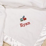Your Personalized Baby Blanket is a heavy knit with ultra fine micro fiber yarns and finely sheared on both sides for the softest touch that rivals cashmere with matching color satin edge finish. This white fleece blanket is made of 100% microfiber polyester fabric and measures 30" x 40". Includes FREE Embroidery. Personalize your Baby Blanket with your favorite icon, name, font style and thread color. ( ie. Train / Ryan / Block / Red)
