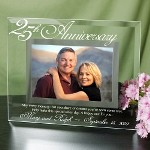 25 years and going strong. Celebrate this glorious milestone with a one-of-a-kind Personalized 25th Anniversary Picture Frame. Your favorite photograph is sure to dazzle everyone as they gaze upon your unique 25th Anniversary gift. Your Personalized 25th Wedding Anniversary Glass Picture Frame measures 9" x 7" and holds a 3½" x 5" or 4" x 6" photo. Easel back allows for desk display. 25th Anniversary frame includes FREE Personalization! Personalized 25th Anniversary Picture Frame with gold accent includes anniversary couples names and anniversary date. 25th Anniversary Picture Frame reads: May every memory that you share of dreams youve seen come true, Help make this special silver day, A Happy one for you.