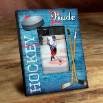 ight the lamp and score a few extra points with the ice hockey lover in your life with our personalized Power Play picture frame. This old fashioned-style picture frame with ice blue faux wood background features colorful images of vintage hockey equipment and players name in bold printing. Ideal for a boy or girl’s room or anywhere hockey aficionados hang their skates! Frames measure 8" x 10" and hold a 4" x 6" picture. 