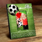 Score a goal and give a nod to one of the worlds most popular sports with this soccer-oriented personalized Kick It Up picture frame. Ideal for soccer lovers of all ages, it makes a great addition to the team room, a childs bedroom, or even the family den. Background is turf green faux-wood and features the players name. Frames measure 8" x 10" and hold a 4" x 6" picture. 