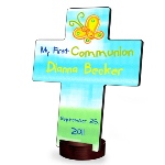 A great way to say "God Bless" to that special boy or girl on the occasion of their First Holy Communion, our personalized crosses range from wistful to whimsical and include bright colors and lively prints. Lovely gifts for a boy or girl, these crosses mark an important day in the child’s religious life and will be treasured for years to come. Includes the childs name and the date of the event. Printed on a composite base for long-lasting quality. Small stand included. Cross measures 6 3/4" x 5 1/8" x 1/4". Stand measures 1 3/4" in diameter and stands 3/4" tall. Select design and personalize with name and date of up to 20 characters each.