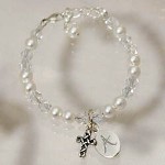 The baptism of your little girl is a glorious day for the family and your precious little girl. Honor this day and keep this treasured moment forever with an Engraved Baptism Bracelet created especially for her. A loving gift celebrating her union with God. Your Personalized Pearl Baptism Bracelet is pearl and clear Swarovski crystal with silver cross. Includes FREE Engraving. Personalize your Baptismal Bracelet with any initial. ( ie. B )