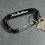 Know your keys are close at hand with our Personalized Carabiner Key Chain. It takes away the worry over lost keys. Your sturdy, all metal with anodized finish Personalized Keychain is sure to look good at the gym or on you hip. Engraved Keychains make great groomsman gifts or graduation gifts, 16th birthday gifts, gifts for dad. Your Personalized Name Clip Key Chain measures 1 1/2" x 3" folded. This durable and practical key chain is perfect for any guy on the go. Includes FREE Engraving. Personalize your Carabiner Keychain with any name in block or script lettering with a choice of 3 colors - Black, Red or Blue. ( ie. Nicholas / Script / Black )