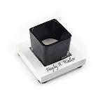 The wood and glass candle holder features a white base and contrasting black tea light holder. The 3.5" by 3.5" by 2.75" candle holder can be personalized with a name or date on the wooden base, for a distinguished birthday, graduation or housewarming gift. This neutral candle holder will make a great addition to an office, desk or table.