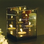 Give your closest friend a bridesmaid gift she will truly enjoy, with this elegant tea light holder from Memorable Gifts. This 4" by 4" by 5.2" candle holder features a tinted glass design and holds a single tea light candle, and makes a great remembrance of your special day. These gifts for bridesmaids, or gifts for maid of honor, can be laser engraved with the names of all the women in your wedding party, and each tea light holder includes the phrase "Thank you for being my bridesmaid."