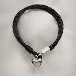 This Black Leather Bracelet with 925 Sterling Silver Heart Charm can be engraved with one initial on front of Heart. Heart is accented with black ring charm. We highly recommend an upright script font. Width of bracelet is 1/2 inch or 10mm. This item allows for one letter to be personalized on the heart.