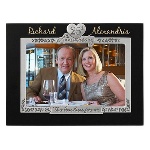 A milestone event like an Anniversary deserves a beautiful frame to display the couple who have reached 25 years of marriage. This beautiful dark brown wood picture frame has an elegant silver metal design surrounding the opening for the 4” x 6” photo and a heart shaped charm with 25th Anniversary on the top. When the couple’s first names are personalized on the 25th wedding anniversary picture frame, this will truly be a memorable gift that will be cherished for the rest of their years together. Frame measures 8.25" x.50" x 6.25". 
