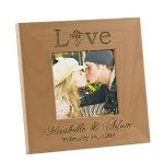 Choose a truly signature gift with our delightful Love photo frame. Designed of quality wood, this unique romantic gift idea features the word Love written across the top with a double heart design. The couples names are engraved along the bottom of the wooden frame. Your sense of originality will create a lasting impression.Wooden Love Frame size is 7 1/8" x 7 1/8". Holds 4x4 photo.