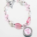 This charming 8" long bracelet makes a great gift for Sweet Sixteen. It is made of a series of dark and light pink acrylic jewels, off-white beads and tiny silver beads. A 0.8" silver-plated frame charm hangs from the bracelet for photo placement. Nickel free.