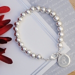 Let our charming Personalized Silver Bead Bracelet be your perfect finishing touch! A modern, yet classic design, this sterling silver-plated bracelet is the perfect "all occasion" wrist bling. From tweens and teens to mothers and grandmothers, this universal bracelet will work with every outfit on every occasion. Fashioned with a lobster claw clasp, personalized charm and silver beads, its great for all the girls on your list! Includes a free organza gift pouch. Great for gifts for daughters, bridesmaids gifts,graduation gifts, sweet 16 gifts, 40th or 50th gifts and retirement gifts.