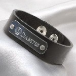 Adjustable snap-closure black leather bracelet with pewter plaque. Stylish design. Quality leather. Fits most child wrist sizes 5 - 6.5 inches. Plaque is darker silver color. Engraving appears in a lighter silver color. Note: In keeping with the style of these bracelets, plaques are not mounted in perfect parallel to the leather strap, but the engraving is centered properly on the plaque.