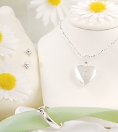Our adorable Sparkling Heart Locket Jewelry Set is an excellent gift for all the young girls on your list. They are sure to feel like a grown up in this timeless, sterling silver-plated locket necklace which accommodates two small pictures. Set includes a locket necklace, pierced earrings, adjustable ring and a complimentary white satin purse embroidered with a first name. Available in silver. Details: Size: Necklace measures 14 inches long. Materials: Sterling silver-plated metal Personalization Options: The Sparkling Heart Locket Jewelry Set may be engraved on the locket with a single block initial, and the complimentary white satin purse may be embroidered with a block first name (max of 12 characters) in pink thread at No Additional Cost. 