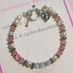 Honor a new grandmother with this special Messages of Love bracelet. Made with Swarovski Crystals and Bali Sterling Silver and a footprint charm hanging next to the toggle. Choose light pink (standard color), baby blue or light green. 