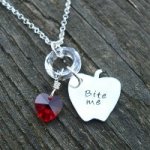 As part of our line of Twilight-inspired jewelry, this unique sterling silver hand-sawn apple says, "Bite me". We can actually stamp any short phrase/words youd like (Edward loves me, Team Edward, Forbidden fruit, etc). Just let us know in the comments when you order! Every apple is hand-sawn from a sheet of solid sterling, and therefore slightly different - but they will all look similar to this one. They are about 3/4" tall. It is suspended from a ring of pure Swarovski crystal on a sterling hand-finished chain. Accented by a red Swarovski crystal heart (also available in clear, topaz, and pink - choose below!).